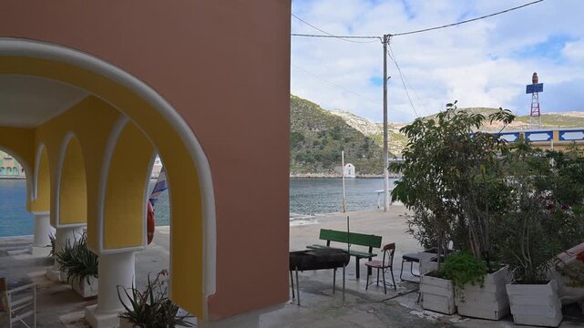 Pastel building with yellow arches in Kastellorizo, Greece