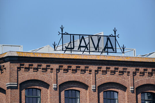 Wormer, Netherlands - 08 May 2026: View of the historic Java building facade with its iconic rooftop sign and brick industrial architecture along the Zaan river.