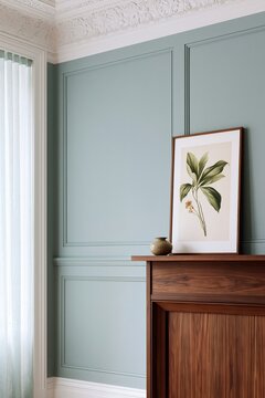 Living room corner featuring a dark walnut mantelpiece with a decorative vase and framed botanical artwork against a soft blue wall and sheer curtains