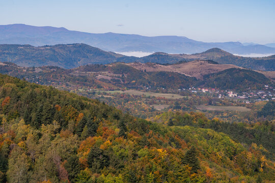 Aerial view of Sitno mountain surrounded by colorful autumn forests and rolling hills in Ilija, Banska Bystrica Region, Slovakia.