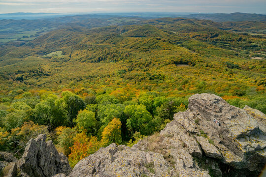 Aerial view of Sitno in Stiavnicke Vrchy with vibrant autumn foliage covering the rolling hills and rocky outcrops, Ilija, Banska Bystrica Regio, Slovakia.