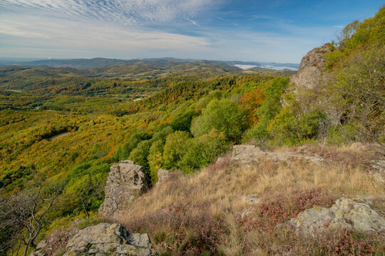Aerial view of Sitno in Stiavnicke Vrchy with autumn foliage, rocky outcrops, and rolling hills in Ilija, Banska Bystrica Regio, Slovakia.