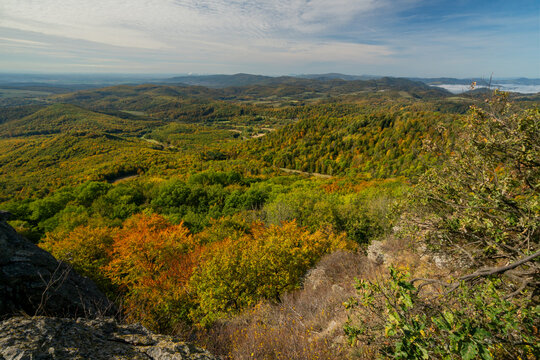 Aerial view of Sitno in Stiavnicke Vrchy with vibrant autumn foliage covering the rolling hills and dense forests in Ilija, Banska Bystrica Regio, Slovakia.
