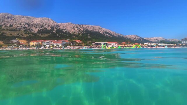 Half underwater video featuring the crystal clear Adriatic Sea and the famous beach of Ba&scaron;ka on Krk Island, Croatia