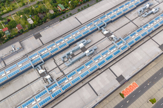Aerial view of Factory Annopol featuring a large industrial rooftop with numerous skylights, ventilation units, and adjacent roads in Warszawa, Wojewodztwo mazowieckie, Poland.