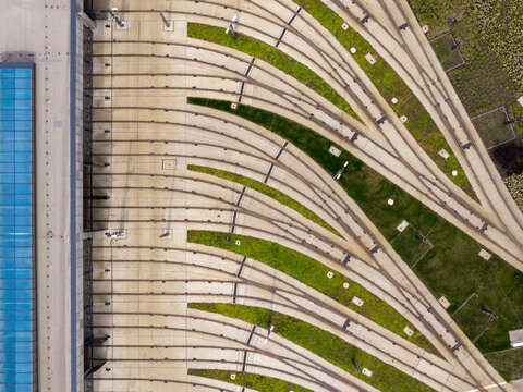 Aerial view of the tram tracks at Zajezdnia Annopol 01 with concrete sleepers and green grass strips in Warsaw, Masovian Voivodeship, Poland.