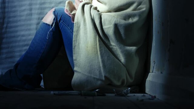 Woman in blanket in abandoned house