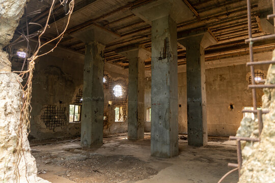 View of the weathered concrete interior of the historic North Field Base featuring exposed rebar and structural columns in Northern Tinian, Tinian, Northern Mariana Islands.