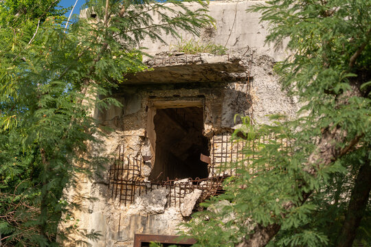 View of the historic North Field Base ruins with weathered concrete walls and exposed rebar in Northern Tinian, Tinian, Northern Mariana Islands.
