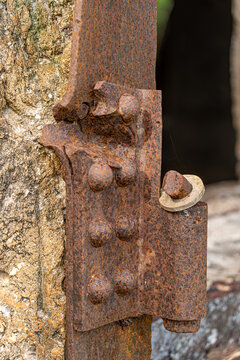 View of a weathered, rusted metal hinge attached to a stone structure at the historic North Field Base in Northern Tinian, Tinian, Northern Mariana Islands.