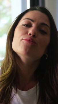 A charismatic woman shares her thoughts and emotions, engaging the viewer with her expressive face and animated conversation. Her genuine smiles and dynamic gestures convey warmth and authenticity.