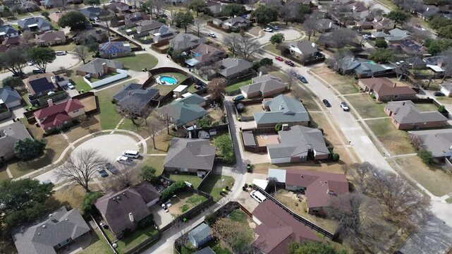 Quiet residential streets surrounding the cul de sac showcase dense neighborhood homes near North Central Expressway. Brown shingled roofs and dormant winter lawns spread across Plano, Texas