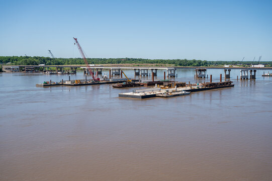 View of construction barges with cranes on the Mississippi River near the Old Chain of Rocks Bridge in St. Louis, Missouri, United States.