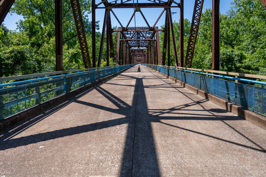 View of the historic Old Chain of Rocks Bridge with its steel truss structure and blue railings spanning across the Mississippi River in St. Louis, Missouri, United States.