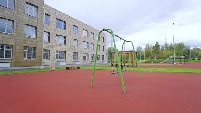 Spacious outdoor recreation zone features various equipment for kids activities. Rubber flooring ensures safe environment in school yard