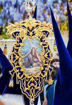 Silent Nazarenos Guiding a Banner Where Art and Suffering Converge in Granada