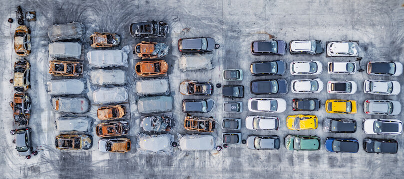 Livron-sur-Drome, France - 20 June 2026: Aerial view of a vehicle salvage yard with damaged and end-of-life cars stored in organized rows on a concrete lot.