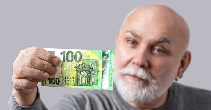 Rich old grandfather businessman freelancer working money euro cash. Cash, currency, wealth, finance, prosperity. Old man holding euro banknotes