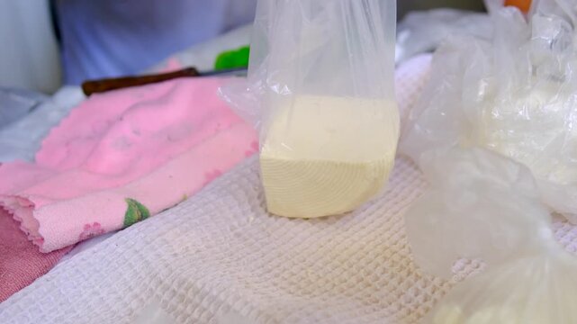 Fresh homemade brynza cheese sold at local market traditional dairy product packed and weighed for customer