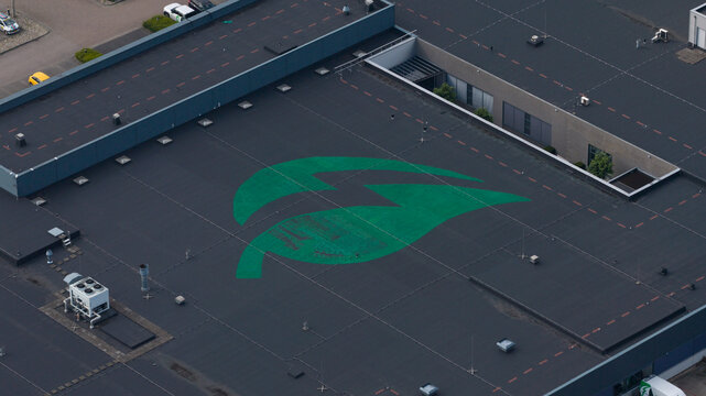 Duiven, Gelderland, Netherlands - 16 June 2026: Aerial view of the Volta Energy logo on a flat industrial building roof with ventilation units and markings.