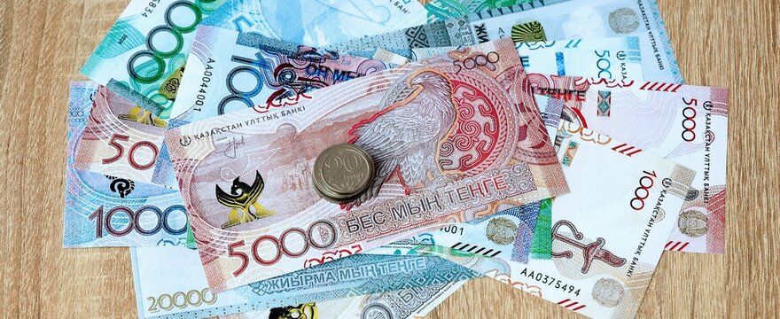 Kazakhstani tenge money bills and coins on table. Kazakhstan cash of KZT currency