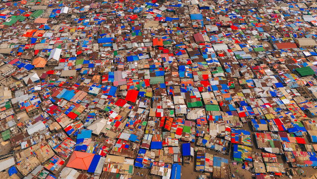 Monrovia, Liberia - 19 June 2026: Aerial view of West Point, a densely populated neighborhood featuring a vast expanse of colorful corrugated metal rooftops.