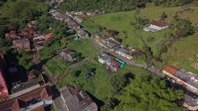 Aerial view of colorful colonial houses and church in lush green Jerico, Colombia