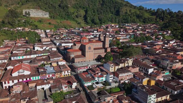 Aerial view of Jerico's colorful colonial town center with large church and hills