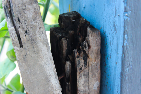 Close Up of Weathered and Rotten Wooden Structure with Blue Painted Wall