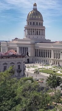View of the iconic El Capitolio building in Havana featuring its grand dome, neoclassical columns, and surrounding gardens in Havana, Havana, Cuba.