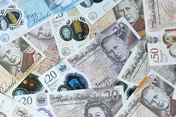 British pound money bills in pile on table. United Kingdom GBP currency cash
