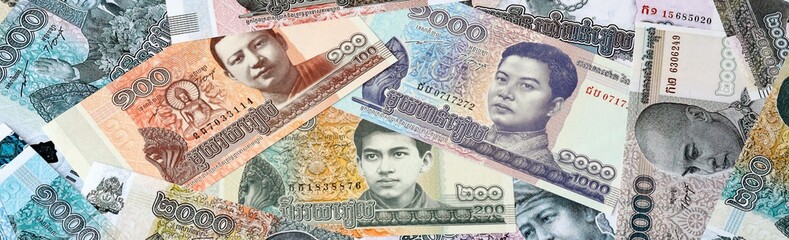 Cambodian riel money bills in pile on table. Cambodia KHR currency cash close up © Viktor