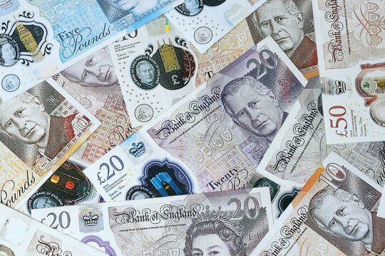 British pound money bills in pile on table. United Kingdom GBP currency cash
