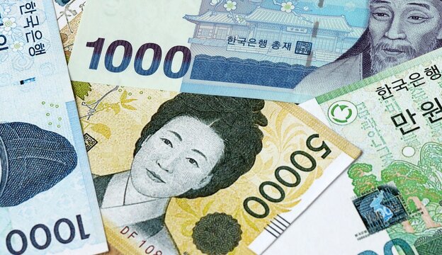 South Korean won money bills in pile on table. South Korea KRW currency cash close up