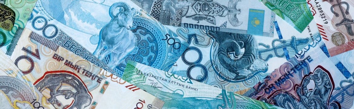 Kazakhstani tenge money bills in pile on table. Kazakhstan KZT currency cash close up