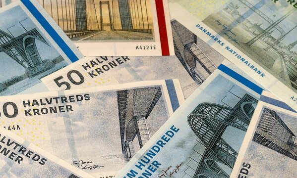 Danish krone money bills in pile on table. Denmark DKK currency cash close up
