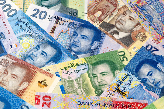 Moroccan dirham money bills in pile on table. Morocco MAD currency cash close up