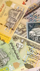 Fototapeta premium Yemeni rial money bills in pile on table. Yemen YER currency cash close up