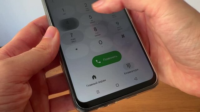 Close-up video of a person entering a phone number on a smartphone keypad. Modern communication concept representing phone calls, mobile technology and digital connectivity.