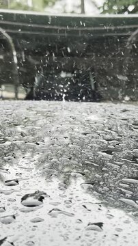 Cinematic Slow Motion: Heavy Raindrops Splashing on a Car Roof