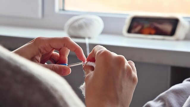 Person using dental floss to clean teeth at home