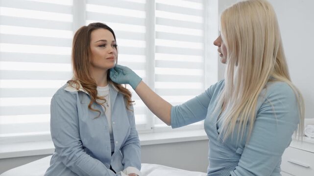 At a cosmetologists office, a skilled practitioner assesses the patients skin and discusses personalized skincare solutions tailored to their unique needs, ensuring optimal results and satisfaction