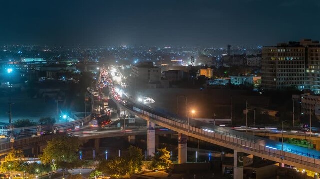 View of night traffic on the elevated highway with city lights illuminating the urban landscape in Karachi, Sindh, Pakistan.