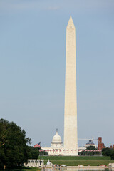 Obraz premium View of Washington Monument and United States Capitol with flags and people on the National Mall in Washington, DC. g.