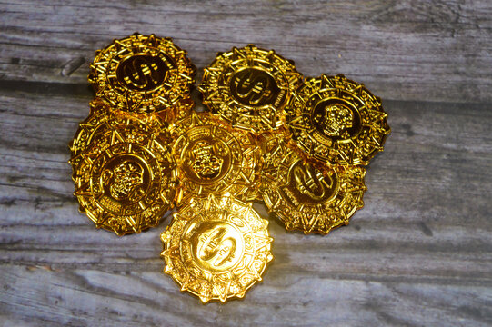 Pirates of the Caribbean Gold Plastic Skull Coins, featuring the iconic Aztec coin design, made of plastic and sold in bulk sets for parties or games