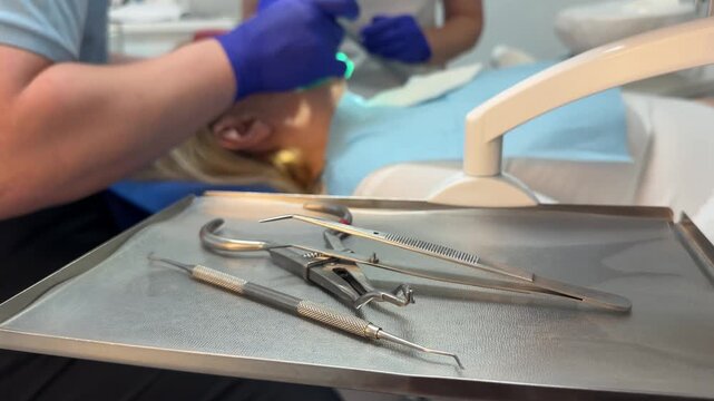 Complete dental filling procedure with patient dentist microscope anesthesia rubber dam and modern restorative treatment set. professional dental care.