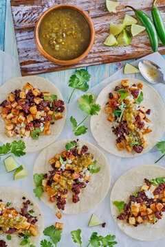 chorizo and potato tacos topped with fresh cilantro and lime juice