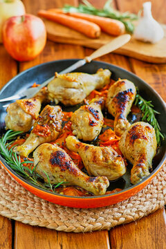 apple cider braised chicken drumsticks finished under the broiler with roasted vegetables