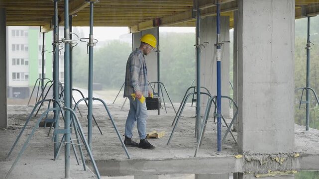Construction worker preparing his toolbox on site