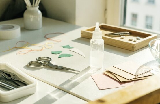 DIY crafting supplies laid out on a table with natural light streaming in